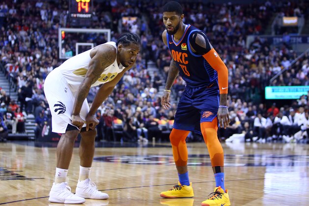 TORONTO, ON - MARCH 22:  Kawhi Leonard #2 of the Toronto Raptors and Paul George #13 of the Oklahoma City Thunder prepare for play to resume during the second half of an NBA game at Scotiabank Arena on March 22, 2019 in Toronto, Canada.  NOTE TO USER: User expressly acknowledges and agrees that, by downloading and or using this photograph, User is consenting to the terms and conditions of the Getty Images License Agreement.  (Photo by Vaughn Ridley/Getty Images)