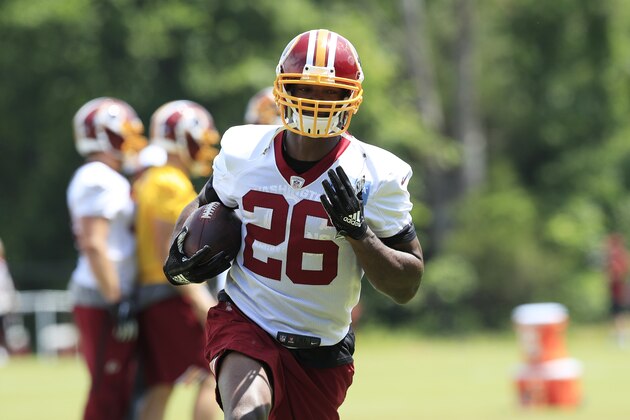Washington Redskins running back Adrian Peterson (26) runs with the ball during an NFL football minicamp at Redskins Park in Ashburn, Va., Thursday, June 6, 2019. (AP Photo/Manuel Balce Ceneta)