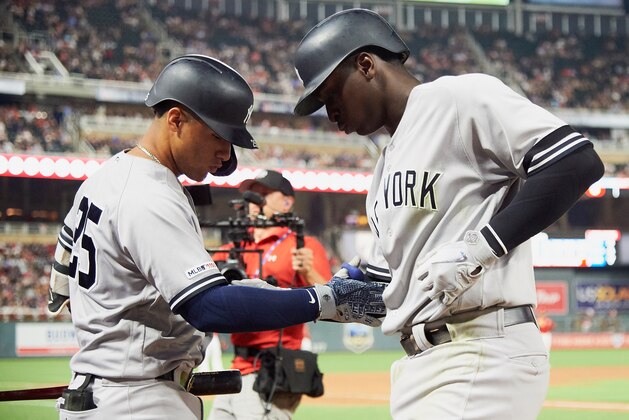 MINNEAPOLIS, MN - JULY 23: Gleyber Torres #25 of the New York Yankees congratulates teammate Didi Gregorius #18 on a three-run home run against the Minnesota Twins during the fifth inning of the game on July 23, 2019 at Target Field in Minneapolis, Minnesota. (Photo by Hannah Foslien/Getty Images)