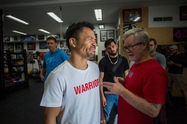 Filipino boxer Manny Pacquiao (L) talks to trainer Freddie Roach after an afternoon training session at Wild Card Boxing in Los Angeles on June 20, 2019. - Veteran trainer Freddie Roach says Manny Pacquiao has rediscovered his aggressive streak as the one-month countdown to his battle with welterweight champion Keith Thurman got under way on June 20. (Photo by Apu Gomes / AFP)        (Photo credit should read APU GOMES/AFP/Getty Images)