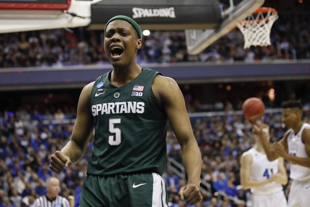 Michigan State guard Cassius Winston (5) reacts to scoring on Duke during the first half of an NCAA men's East Regional final college basketball game in Washington, Sunday, March 31, 2019. (AP Photo/Alex Brandon)