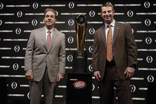 Alabama head coach Nick Saban and Clemson head coach Dabo Swinney pose with the trophy at a news conference for the NCAA college football playoff championship game Sunday, Jan. 6, 2019, in Santa Clara, Calif. (AP Photo/David J. Phillip)