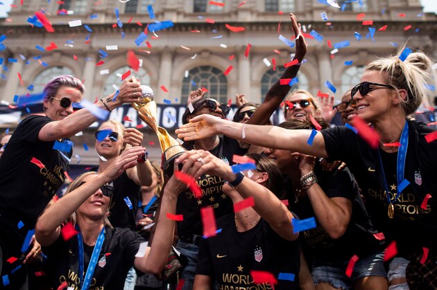 Members of the World Cup-winning US women's team take part in a ticker tape parade with their trophy for the women's World Cup champions on July 10, 2019 in New York. - Tens of thousands of fans are poised to pack the streets of New York on Wednesday to salute the World Cup-winning US women's team in a ticker-tape parade. Four years after roaring fans lined the route of Lower Manhattan's fabled