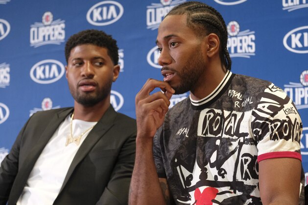 Paul George, left, and Kawhi Leonard attend a press conference  in Los Angeles, Wednesday, July 24, 2019. Nearly three weeks after the native Southern California superstars shook up the NBA by teaming up with the Los Angeles Clippers, the dynamic duo makes its first public appearance. (AP Photo/Ringo H.W. Chiu)