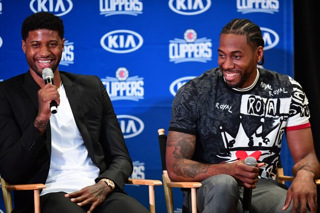 US basketball players Kawhi Leonard (R) and Paul George laugh during a press conference to introduce them as the new players of the Los Angeles Clippers in Los Angeles on July 24, 2019. (Photo by FREDERIC J. BROWN / AFP)        (Photo credit should read FREDERIC J. BROWN/AFP/Getty Images)