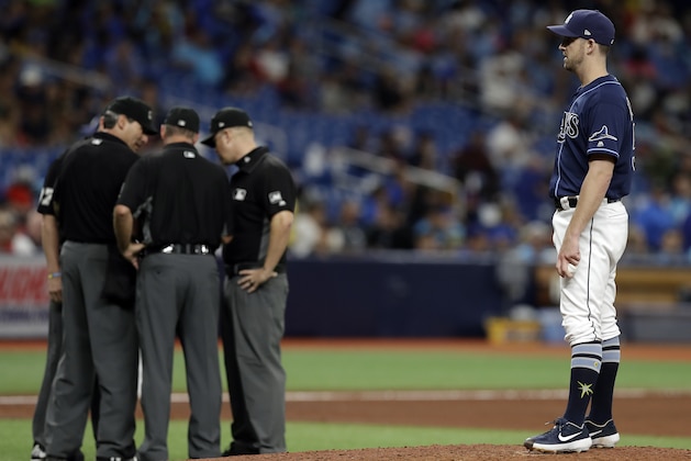Tampa Bay Rays relief pitcher Adam Kolarek waits as umpire confer during the eighth inning of a baseball game against the Boston Red Sox Wednesday, July 24, 2019, in St. Petersburg, Fla. Kalrek was pitching, then moved to first base, and then back to pitcher in the inning. (AP Photo/Chris O'Meara)