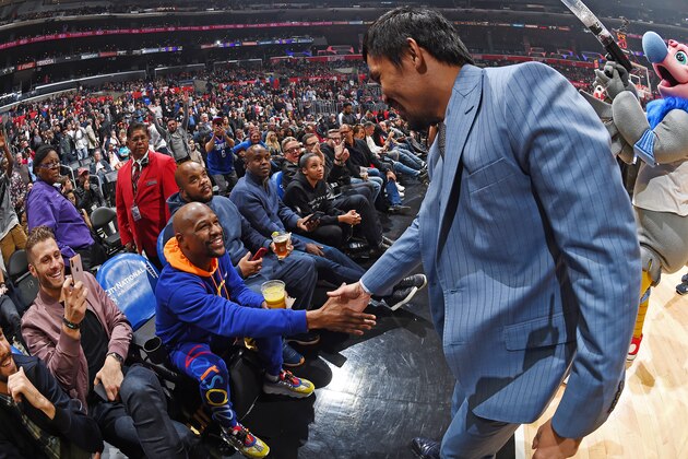 LOS ANGELES, CA - JANUARY 8: Professional Boxers Floyd Mayweather and Manny Pacquiao greet each other during the game between the Charlotte Hornets and LA Clippers on January 8, 2019 at STAPLES Center in Los Angeles, California. NOTE TO USER: User expressly acknowledges and agrees that, by downloading and/or using this Photograph, user is consenting to the terms and conditions of the Getty Images License Agreement. Mandatory Copyright Notice: Copyright 2019 NBAE (Photo by Andrew D. Bernstein/NBAE via Getty Images)