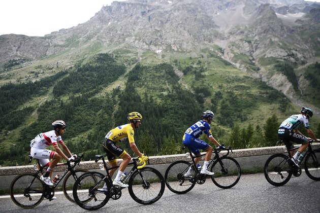 France's Julian Alaphilippe (2ndL), wearing the overall leader's yellow jersey, Spain's Enric Mas (2ndR), Austria's Gregor Muhlberger (R) and Italy's Fabio Aru ride up during the eighteenth stage of the 106th edition of the Tour de France cycling race between Embrun and Valloire, in Valloire, on July 25, 2019. (Photo by Anne-Christine POUJOULAT / AFP)        (Photo credit should read ANNE-CHRISTINE POUJOULAT/AFP/Getty Images)