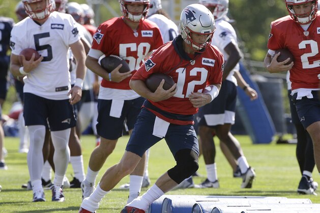 New England Patriots quarterbacks Danny Etling (5), Jarrett Stidham (58), Tom Brady (12), and Brian Hoyer (2), perform field drills during an NFL football training camp practice, Thursday, July 25, 2019, in Foxborough, Mass. (AP Photo/Steven Senne)