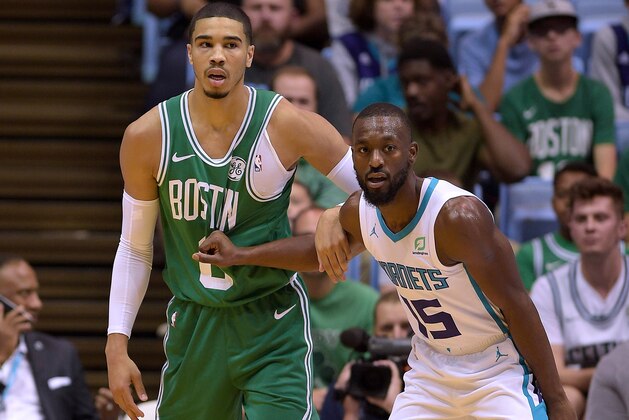 CHAPEL HILL, NC - SEPTEMBER 28: Kemba Walker #15 of the Charlotte Hornets defends Jayson Tatum #0 of the Boston Celtics in the first quarter of a preseason game at Dean Smith Center on September 28, 2018 in Chapel Hill, North Carolina. NOTE TO USER: User expressly acknowledges and agrees that, by downloading and or using this photograph, User is consenting to the terms and conditions of the Getty Images License Agreement. The Hornets won 104-97. (Photo by Lance King/Getty Images)