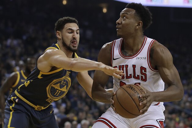 Chicago Bulls' Wendell Carter Jr., right, looks to shoot against Golden State Warriors' Klay Thompson (11) during the first half of an NBA basketball game Friday, Jan. 11, 2019, in Oakland, Calif. (AP Photo/Ben Margot)