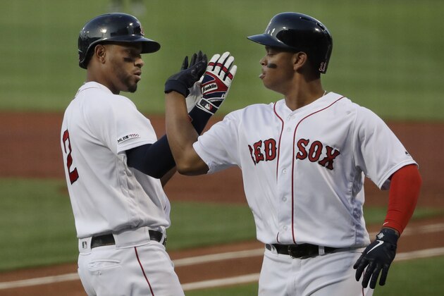 Boston Red Sox's Xander Bogaerts, left, celebrates his three-run homer with teammate Rafael Devers in the first inning of a baseball game against the New York Yankees at Fenway Park, Thursday, July 25, 2019, in Boston. (AP Photo/Elise Amendola)