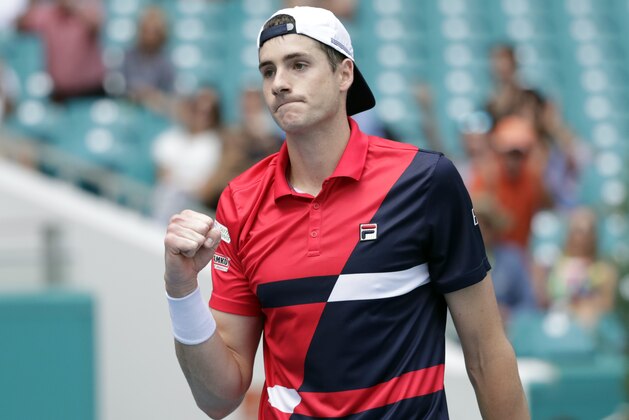 John Isner reacts after defeating Felix Auger-Aliassime, of Canada, during their semifinal match at the Miami Open tennis tournament, Friday, March 29, 2019, in Miami Gardens, Fla. Isner won 7-6 (3), 7-6 (4). (AP Photo/Lynne Sladky)