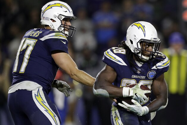 Los Angeles Chargers running back Melvin Gordon (28) gets a hand off from quarterback Philip Rivers from during an NFL football game against the Baltimore Ravens Saturday, Dec. 22, 2018, in Carson, Calif. (AP Photo/Marcio Jose Sanchez)