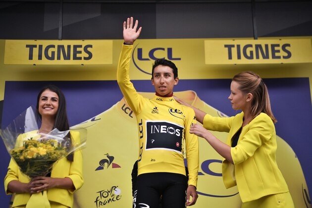 TOPSHOT - Colombia's Egan Bernal (C) celebrates his overall leader's yellow jersey on the podium of the nineteenth stage of the 106th edition of the Tour de France cycling race between Saint-Jean-de-Maurienne and Tignes, in Tignes, on July 26, 2019. (Photo by Marco Bertorello / AFP)        (Photo credit should read MARCO BERTORELLO/AFP/Getty Images)