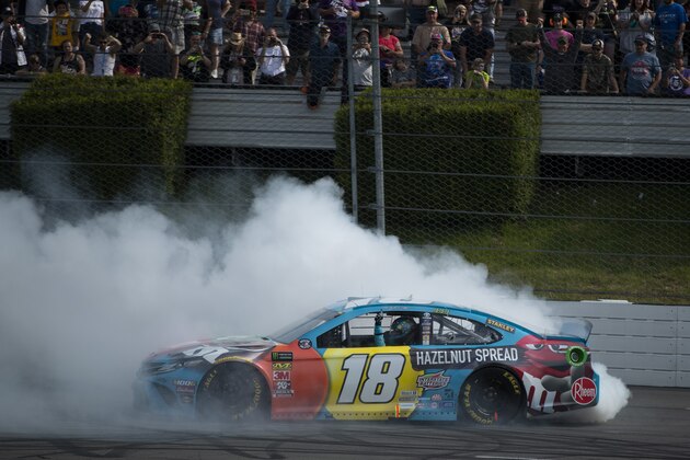 Kyle Busch celebrates after winning a NASCAR Cup Series auto race at Pocono Raceway, Sunday, June 2, 2019, in Long Pond, Pa. (AP Photo/Matt Slocum)