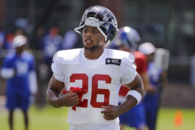New York Giants running back Saquon Barkley (26) practices with teammates at the NFL football team's training camp in Thursday, July 25, 2019, in East Rutherford, N.J. (AP Photo/Frank Franklin II)