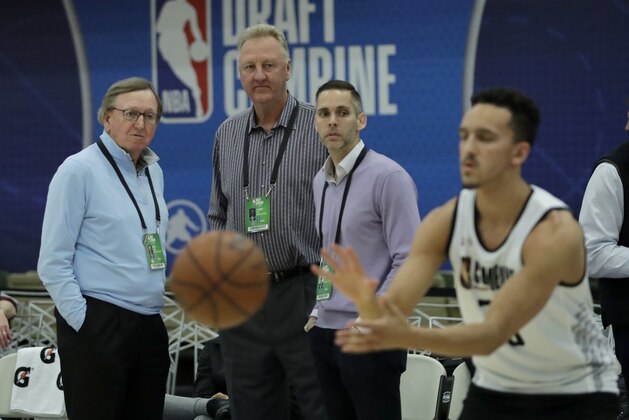 Rod Thorn, left, with the Milwaukee Bucks, Hall of Famer Larry Bird, center, and Ryan West, right, with the Los Angeles Lakers, watch workouts at the NBA draft basketball combine Friday, May 18, 2018, in Chicago. (AP Photo/Charles Rex Arbogast)