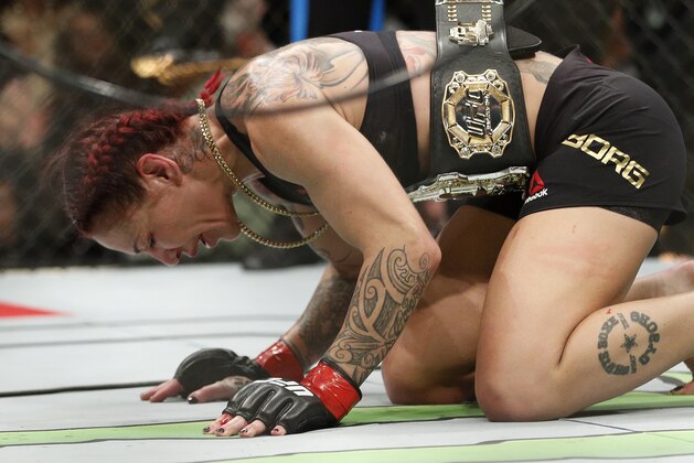 Cris Cyborg celebrates after defeating Holly Holm during a featherweight championship mixed martial arts bout at UFC 219, Saturday, Dec. 30, 2017, in Las Vegas. (AP Photo/John Locher)