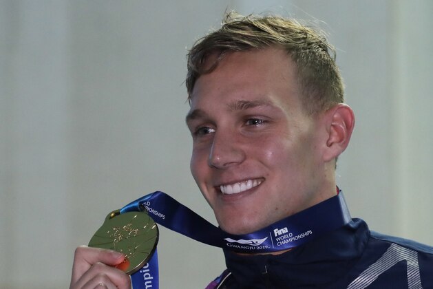 Gold medalist United States' Caeleb Dressel poses with his medal following the men's 100m butterfly final at the World Swimming Championships in Gwangju, South Korea, Saturday, July 27, 2019. (AP Photo/Lee Jin-man)