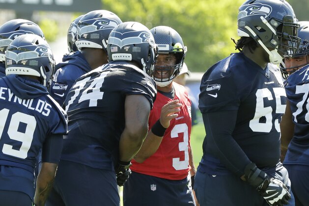 Seattle Seahawks quarterback Russell Wilson (3) talks with offensive tackle George Fant (74) during NFL football training camp, Thursday, July 25, 2019, in Renton, Wash. (AP Photo/Ted S. Warren)
