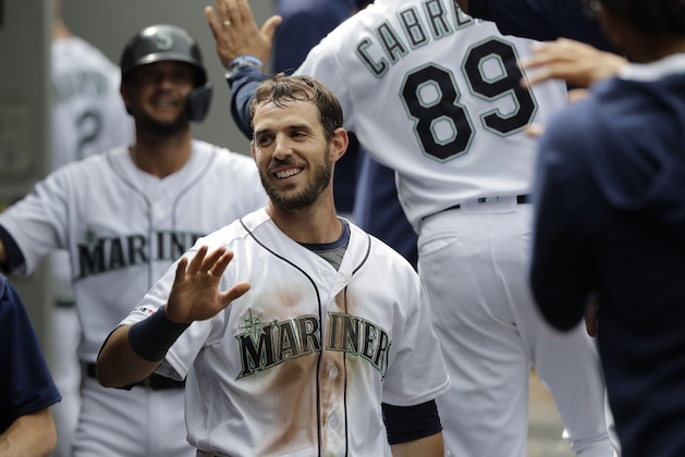 Seattle Mariners' Austin Nola, center, and Kristopher Negron, left, are greeted in the dugout after they scored in the seventh inning of a baseball game against the Detroit Tigers on a ground-rule double hit by teammate Ryan Court, Saturday, July 27, 2019, in Seattle. (AP Photo/Ted S. Warren)