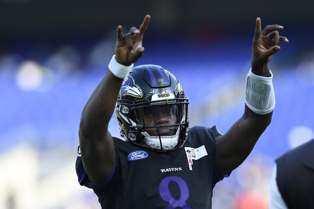 Baltimore Ravens quarterback Lamar Jackson motions to the fans during NFL football training camp Saturday, July 27, 2019, in Baltimore. (AP Photo/Gail Burton)