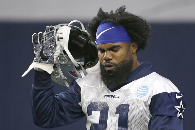 Dallas Cowboys running back Ezekiel Elliott (21) walks the field during an organized team activity at its NFL football training facility in Frisco, Texas, Wednesday, May 29, 2019. (AP Photo/Ron Jenkins)