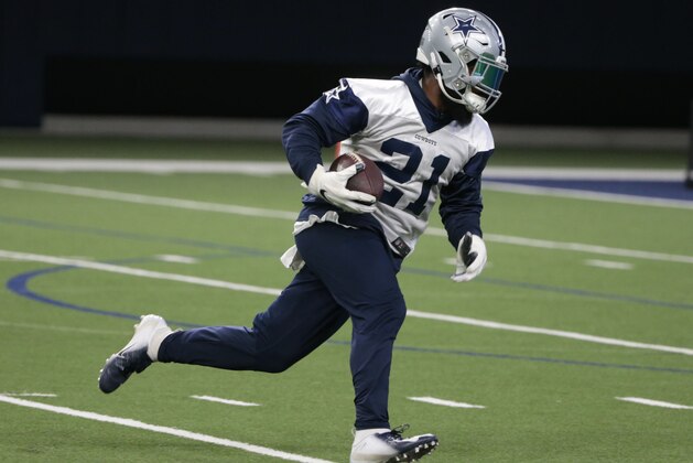 Dallas Cowboys running back Ezekiel Elliott (21) runs a play during NFL football practice in Frisco, Texas, Wednesday, May. 22, 2019. (AP Photo/Michael Ainsworth)