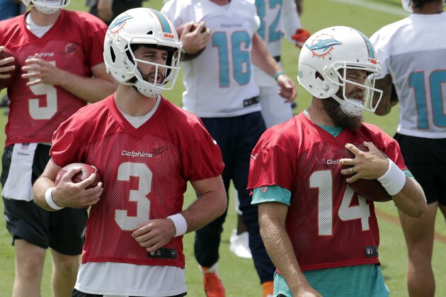 Miami Dolphins quarterback Josh Rosen (3) and Ryan Fitzpatrick (14) do drills during NFL football practice, Tuesday, May 21, 2019, in Davie, Fla. (AP Photo/Lynne Sladky)