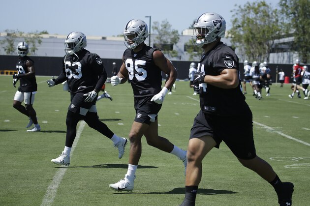 Oakland Raiders' Ronald Ollie (63) and Quinton Bell (95) run during NFL football practice on Tuesday, June 4, 2019, at the team's training facility in Alameda, Calif. (AP Photo/Ben Margot)