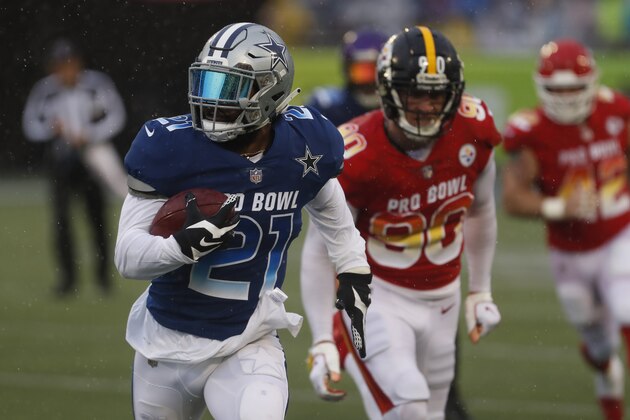 NFC running back Ezekiel Elliott (22), of the Dallas Cowboys, runs away from AFC linebacker T.J. Watt (90), of the Pittsburgh Steelers, during the second half of the NFL Pro Bowl football game Sunday, Jan. 27, 2019, in Orlando, Fla. (AP Photo/Mark LoMoglio)