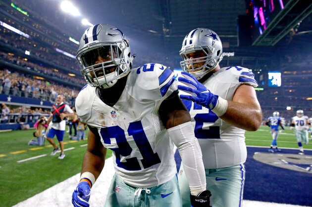 ARLINGTON, TX - DECEMBER 26: Ezekiel Elliott #21 of the Dallas Cowboys celebrates with teammate Travis Frederick #72 after Elliott  scored on a touchdown run against the Detroit Lions during the first half at AT&T Stadium on December 26, 2016 in Arlington, Texas. (Photo by Tom Pennington/Getty Images)