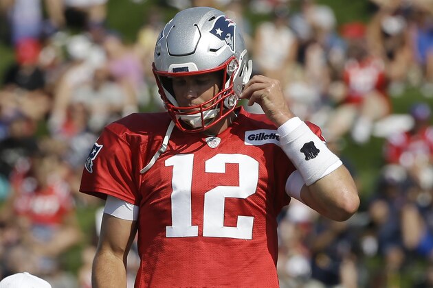New England Patriots quarterback Tom Brady (12) adjusts his helmet during an NFL football training camp practice, Sunday, July 28, 2019, in Foxborough, Mass. (AP Photo/Steven Senne)
