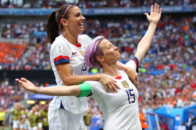 LYON, FRANCE - JULY 07: Megan Rapinoe of the USA celebrates scoring the first goal from the penalty spot with Alex Morgan during the 2019 FIFA Women's World Cup France Final match between The United State of America and The Netherlands at Stade de Lyon on July 07, 2019 in Lyon, France. (Photo by Richard Heathcote/Getty Images)