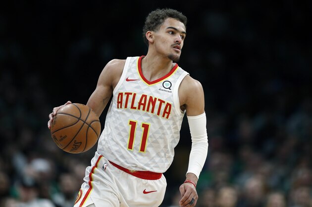 Atlanta Hawks' Trae Young (11) brings the ball up during the second half of an NBA basketball game against the Boston Celtics in Boston, Saturday, March 16, 2019. (AP Photo/Michael Dwyer)