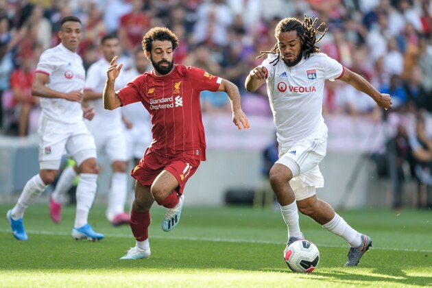 Liverpool's Egyptian midfielder Mohamed Salah (L) and Lyon's Belgian defender Jason Denayer vies for the ball during a pre-season friendly football match between Liverpool and Lyon on July 31, 2019 in Geneva. (Photo by FABRICE COFFRINI / AFP)        (Photo credit should read FABRICE COFFRINI/AFP/Getty Images)