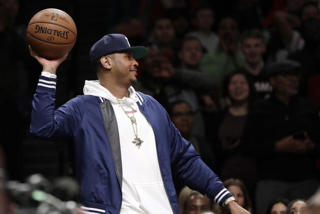 Former NBA player Carmelo Anthony throws the ball back during the second half of an NBA basketball game between the Brooklyn Nets and the Miami Heat, Wednesday, April 10, 2019, in New York. Anthony attended the game to watch the final game of Heat guard Dwyane Wade's NBA career. (AP Photo/Kathy Willens)
