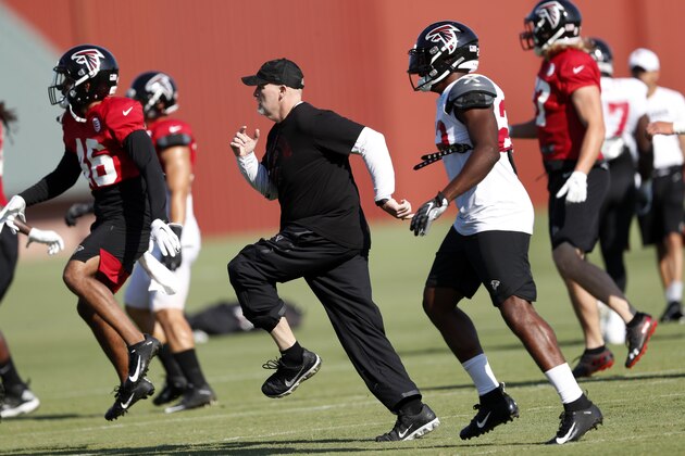 Atlanta Falcons head coach Dan Quinn runs with his players during their NFL training camp football practice Thursday, July 25, 2019, in Flowery Branch, Ga.(AP Photo/John Bazemore)