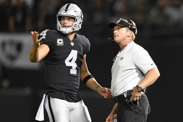 OAKLAND, CA - SEPTEMBER 10:  Derek Carr #4 of the Oakland Raiders speaks with head coach Jon Gruden in the first quarter during their NFL game against the Los Angeles Rams at Oakland-Alameda County Coliseum on September 10, 2018 in Oakland, California.  (Photo by Thearon W. Henderson/Getty Images)