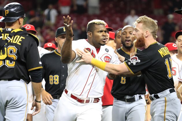 CINCINNATI, OHIO - JULY 30: Yasiel Puig #66 of the Cincinnati Reds is restrained during a bench clearing altercation in the 9th inning of the game against the Pittsburgh Pirates at Great American Ball Park on July 30, 2019 in Cincinnati, Ohio. (Photo by Andy Lyons/Getty Images)