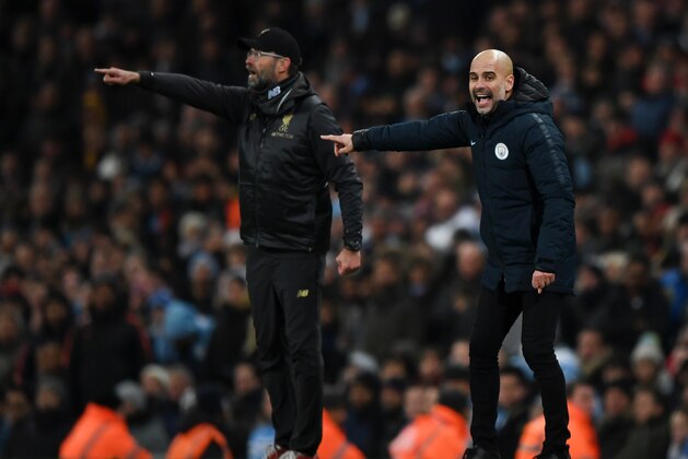 MANCHESTER, ENGLAND - JANUARY 03: Josep Guardiola, Manager of Manchester City and Jurgen Klopp, Manager of Liverpool give their team instructions during the Premier League match between Manchester City and Liverpool FC at the Etihad Stadium on January 3, 2019 in Manchester, United Kingdom.  (Photo by Shaun Botterill/Getty Images)