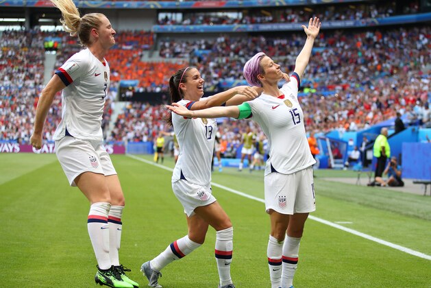 LYON, FRANCE - JULY 07: Megan Rapinoe of the USA celebrates scoring the first goal from the penalty spot with Alex Morgan during the 2019 FIFA Women's World Cup France Final match between The United State of America and The Netherlands at Stade de Lyon on July 07, 2019 in Lyon, France. (Photo by Richard Heathcote/Getty Images)