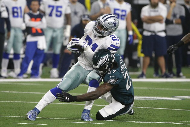 Dallas Cowboys running back Ezekiel Elliott (21) is stopped by Philadelphia Eagles' Malcolm Jenkins (27) during the first half of an NFL football game, in Arlington, Texas, Sunday, Dec. 9, 2018. (AP Photo/Michael Ainsworth)