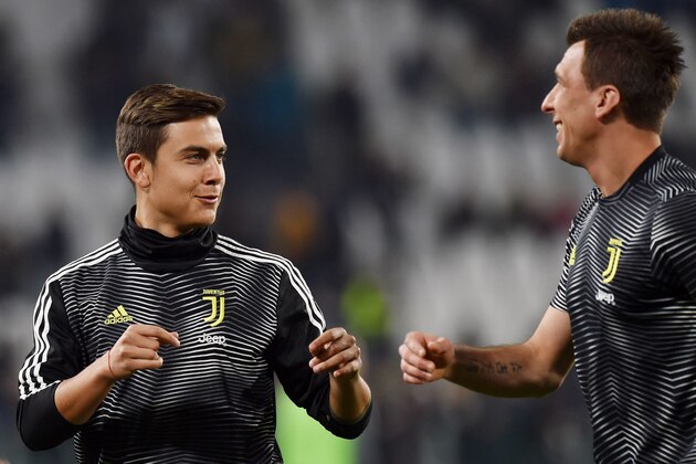 TURIN, ITALY - MARCH 08: Paulo Dybala and Mario Mandzukic of Juventus looks on during the warm-up before the Serie A match between Juventus and Udinese at Allianz Stadium on March 08, 2019 in Turin, Italy. (Photo by Tullio M. Puglia/Getty Images)