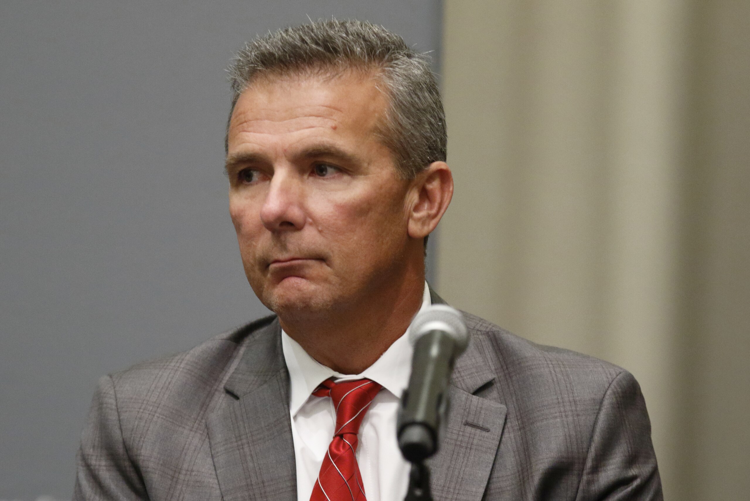 FILE - In this Aug. 22, 2018, file photo, Ohio State University coach Urban Meyer is listens during an NCAA college football press conference in Columbus, Ohio. Meyer will be back on the Ohio State sideline Saturday against Tulane after serving a three-game suspension. He was forced to sit out after the university determined he mismanaged the behavior of former assistant Zach Smith.  (AP Photo/Paul Vernon, File)