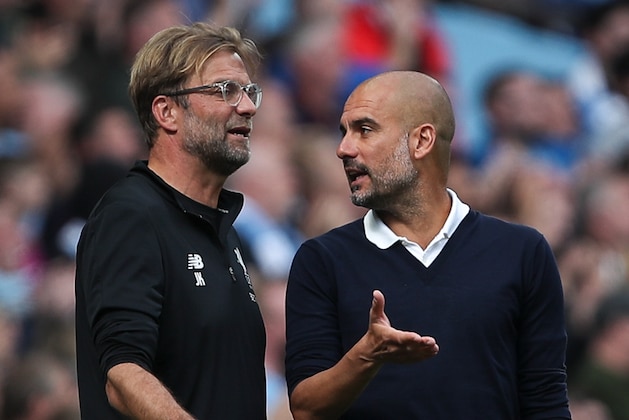 MANCHESTER, ENGLAND - SEPTEMBER 09: Jurgen Klopp manager / head coach of Liverpool and Pep Guardiola the head coach / manager of Manchester City discuss during the Premier League match between Manchester City and Liverpool at Etihad Stadium on September 9, 2017 in Manchester, England. (Photo by Robbie Jay Barratt - AMA/Getty Images)