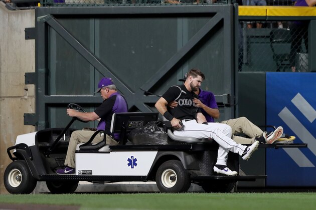 DENVER, COLORADO - AUGUST 02: David Dahl #26 of the Colorado Rockies is carted off the field after being injured in the sixth inning against the San Francisco Giants at Coors Field on August 02, 2019 in Denver, Colorado. (Photo by Matthew Stockman/Getty Images)