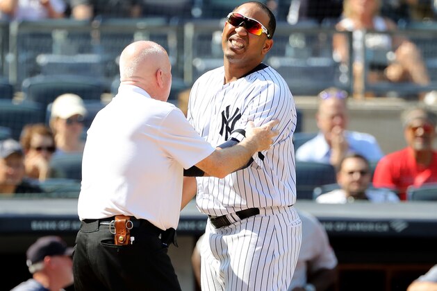 NEW YORK, NEW YORK - AUGUST 03:  Edwin Encarnacion #30 of the New York Yankees is looked at after he was hit by a pitch in the eighth inning against the Boston Red Sox during game one of a double header at Yankee Stadium on August 03, 2019 in the Bronx borough of New York City. (Photo by Elsa/Getty Images)