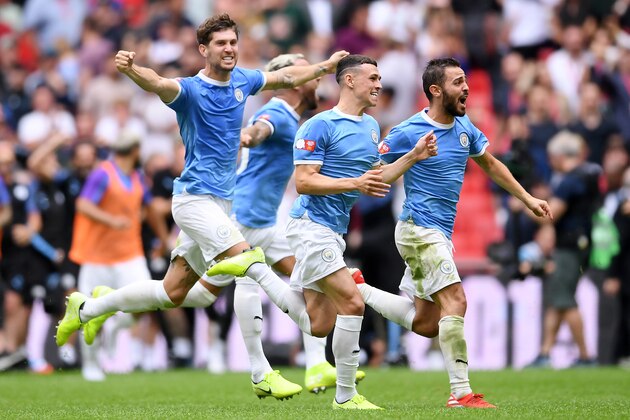 LONDON, ENGLAND - AUGUST 04: Bernardo Silva, Phil Foden and John Stones of Manchester City celebrate following their team's victory in the penalty shoot out during the FA Community Shield match between Liverpool and Manchester City at Wembley Stadium on August 04, 2019 in London, England. (Photo by Laurence Griffiths/Getty Images)